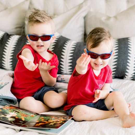 Boys playing while wearing TrueDark Kids Superhero Twilights glasses