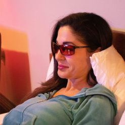 Woman Wearing TrueDark Twilight Elite Glasses while looking at her phone