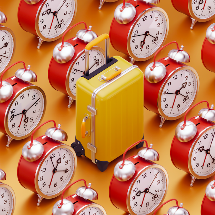 Red clocks and yellow luggage on orange background