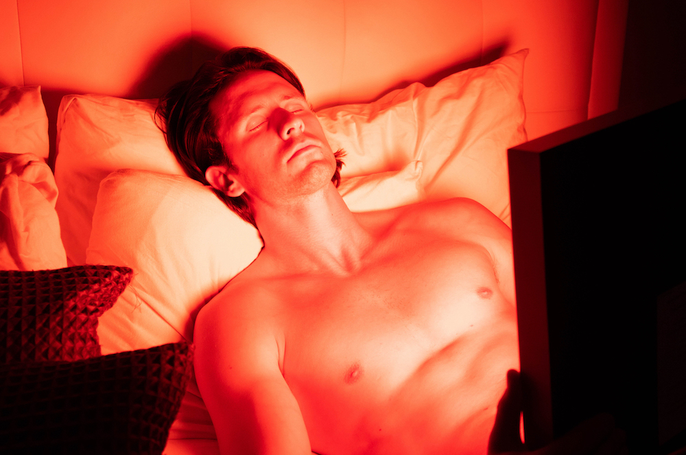 Man using a TrueLight LED light therapy device