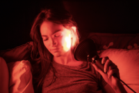 Woman using a TrueLight Energy Scarlet Lux LED Light Therapy Device