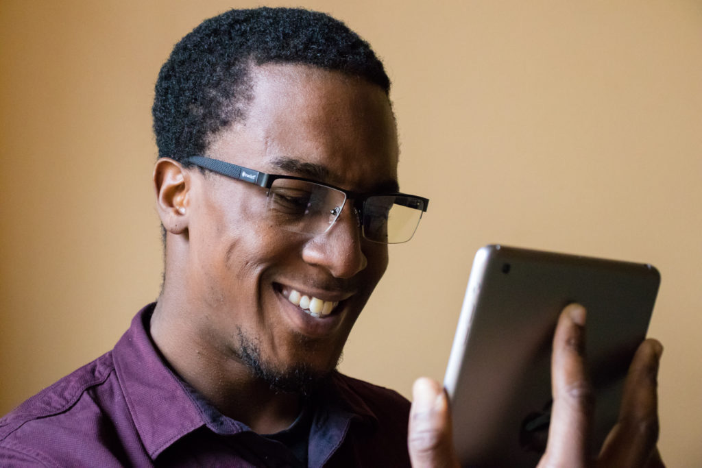 Man wearing Daylight Readers while using a tablet