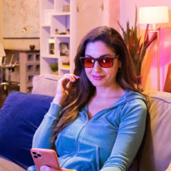Woman wearing TrueDark Twilights Fairlane Glasses for nighttime blue-light blocking