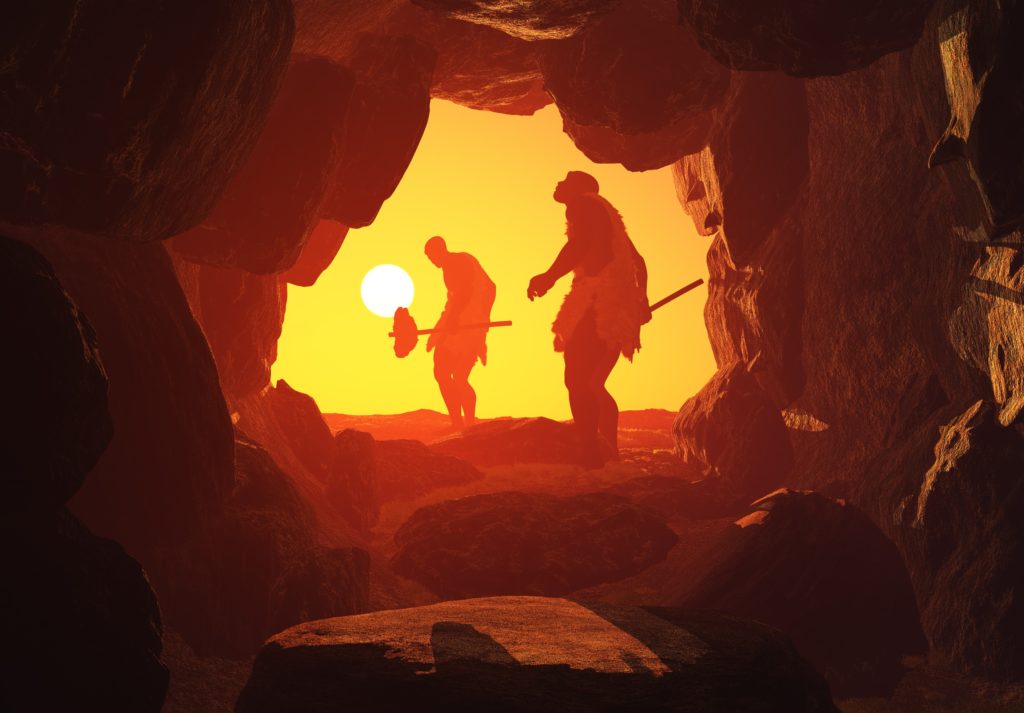 looking out of a cave during sunset, silhouettes of men blocking light