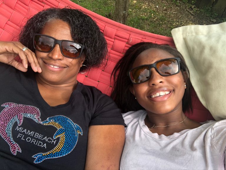 Mother and Daughter lounging on hammock wearing TrueDark Twilight Elites
