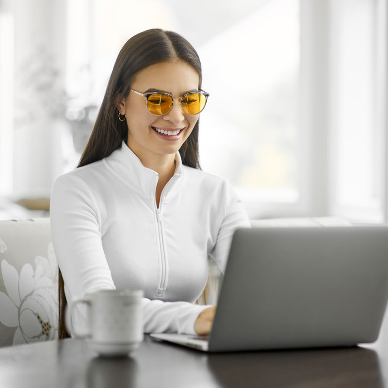 Woman Wearing TrueDark Malibu Yellow Lens Glasses Working Smarter