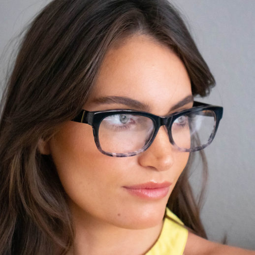 Woman wearing TrueDark Dawning Black + Grey tortoiseshell clear lensed glasses
